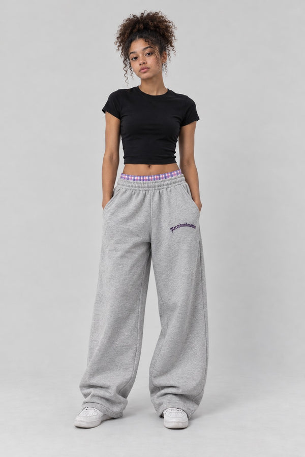 Model wearing the Recordunknown heather grey flannel sweatpants, full-length studio shot