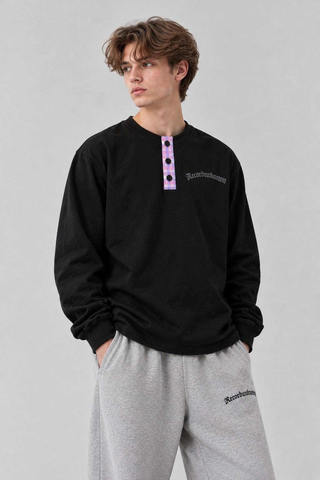 Close-up of the Recordunknown black henley on a model
