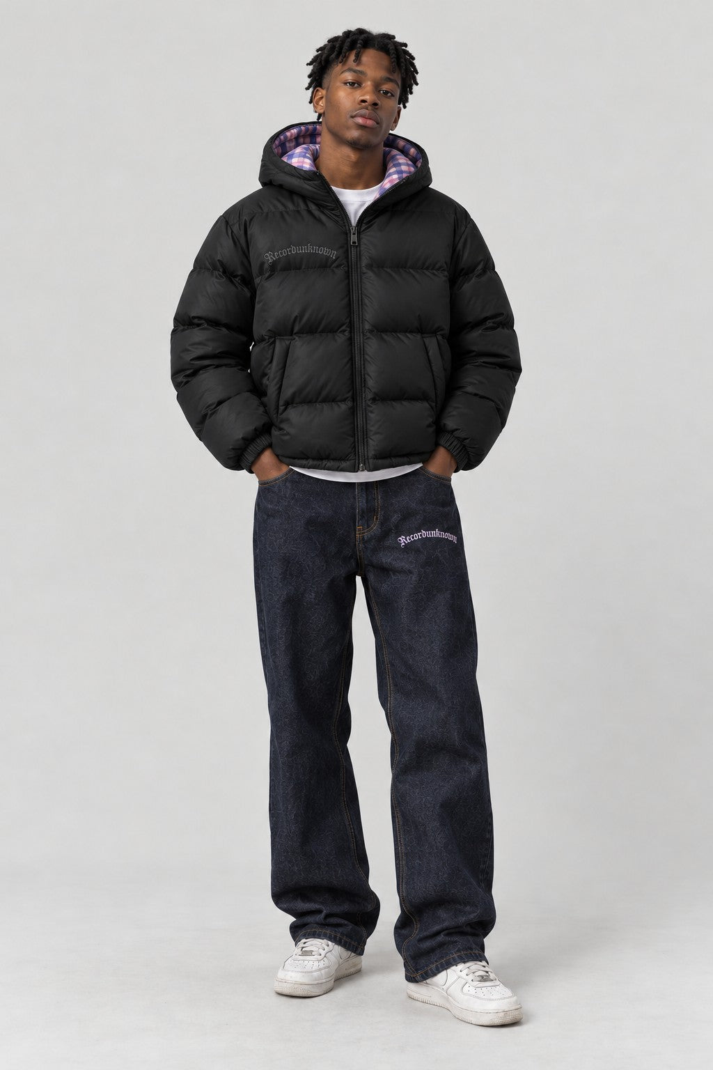Model wearing the Recordunknown black puffer jacket, full-length studio shot