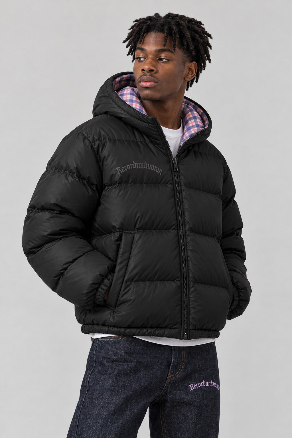 Close-up of the Recordunknown black puffer jacket on a model