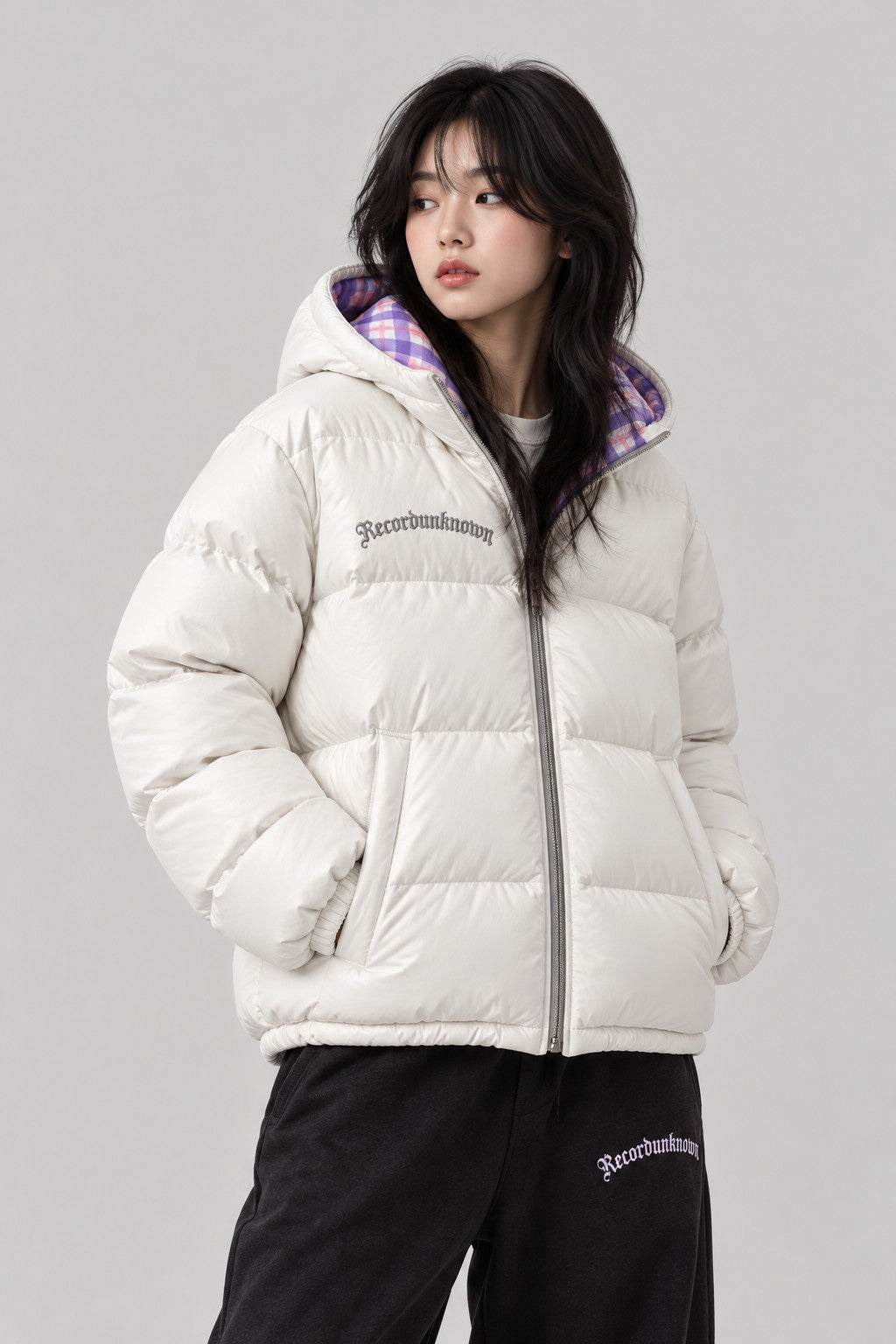 Close-up of the Recordunknown ice white puffer jacket on a model