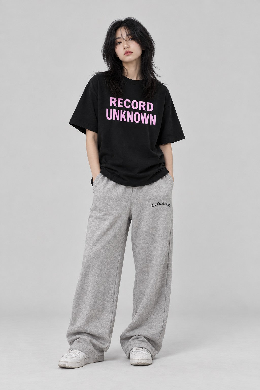 Model wearing the Recordunknown black stacked tee, full-length studio shot